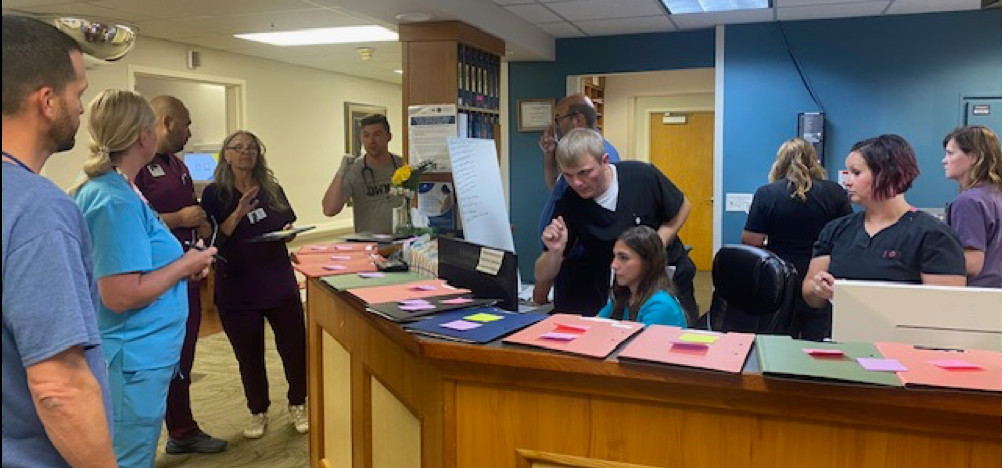 Doctors and nurses standing around a desk