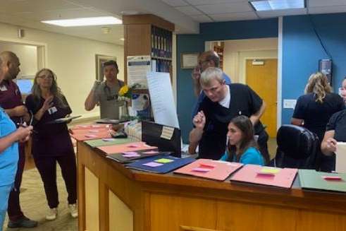 Doctors and nurses standing around a desk